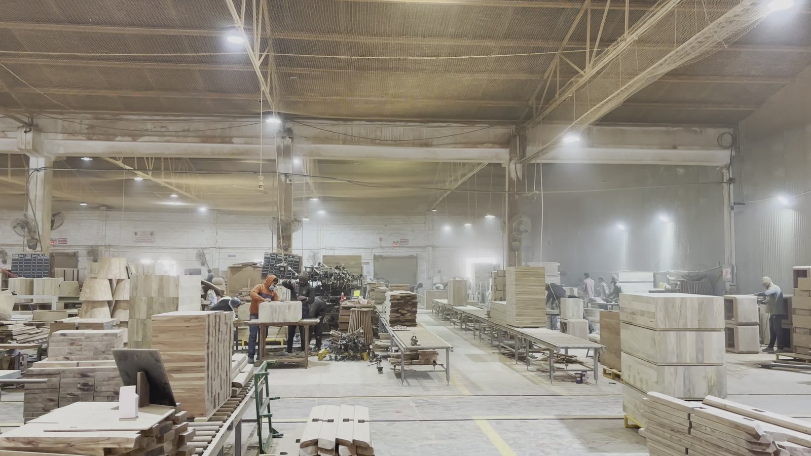 Woodworking workshop interior with production machinery and timber